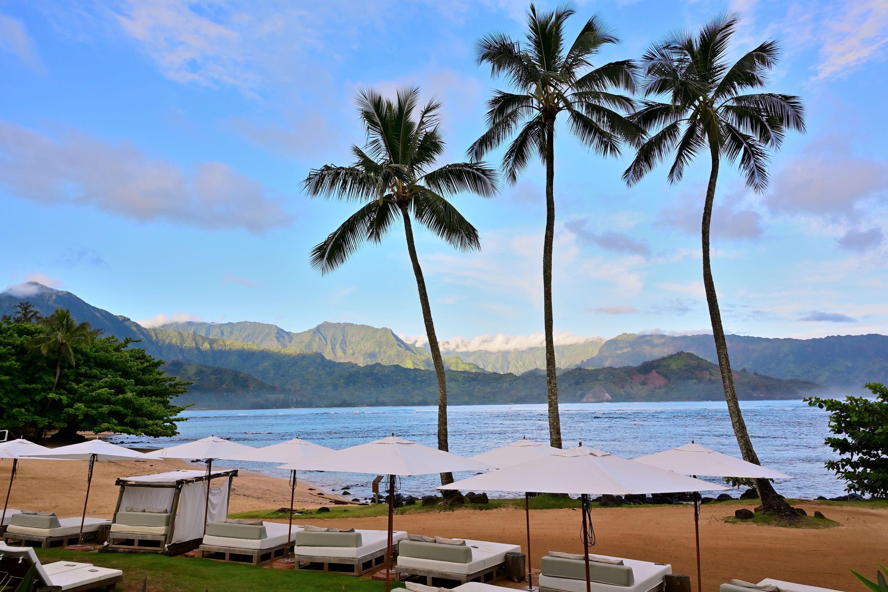 Aerial view of Hanalei Bay's crescent coastline and mountains, Kauai